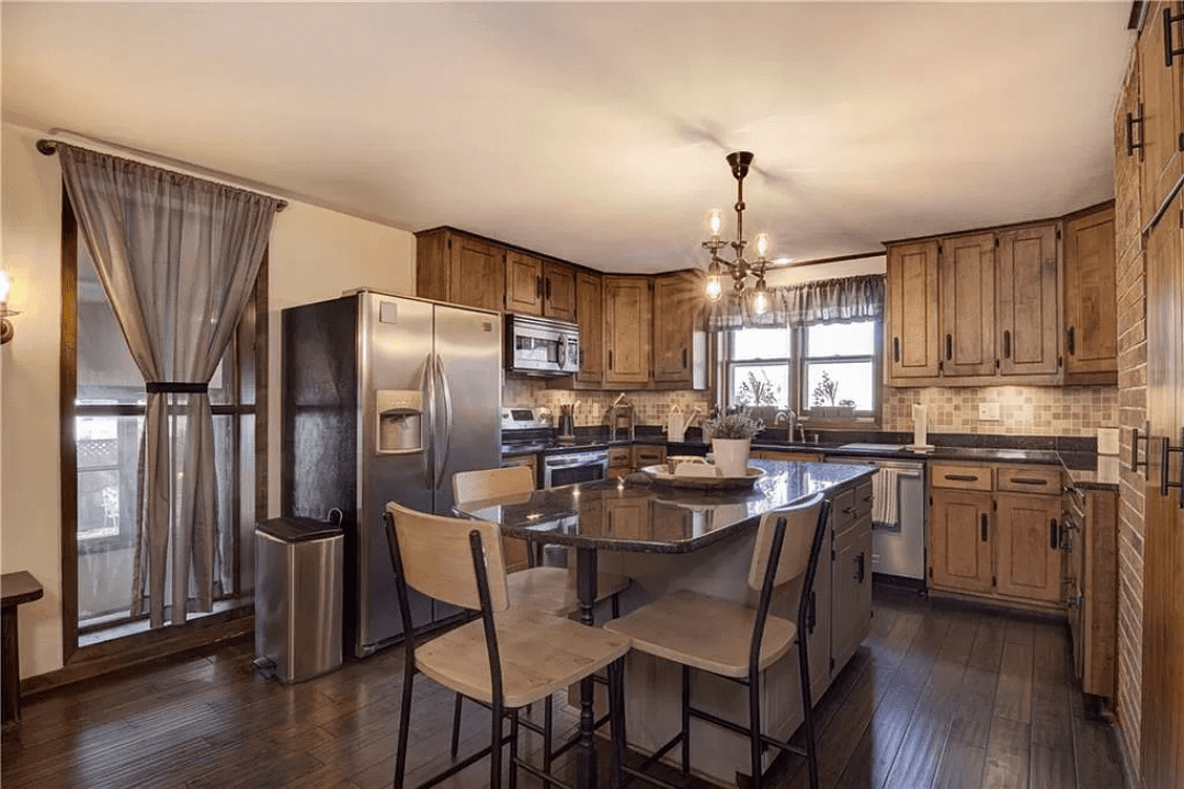 IT'S NOT ALL ANTIQUE. The kitchen includes a central island and quartz countertops.