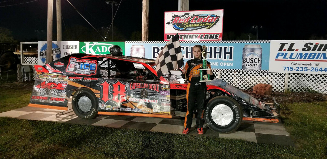 A young Kennedy Swan poses with one of her (many) awards for racing. In her race car, the teenager says she keeps a Perler Bead checkered flag that a little girl made for her and gave her after a race. It was one of many humbling moments in her racing career, she said. (Submitted photo)