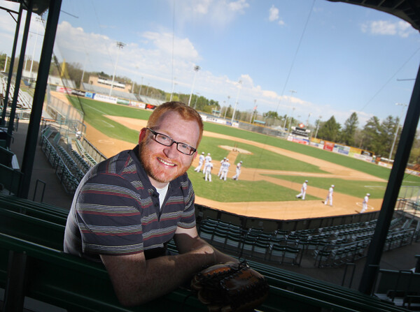 BATTER UP. Joe Niese, shown here at Eau Claire's Carson Park, has written a number of sports-related books. (Photo by Andrea Paulseth)