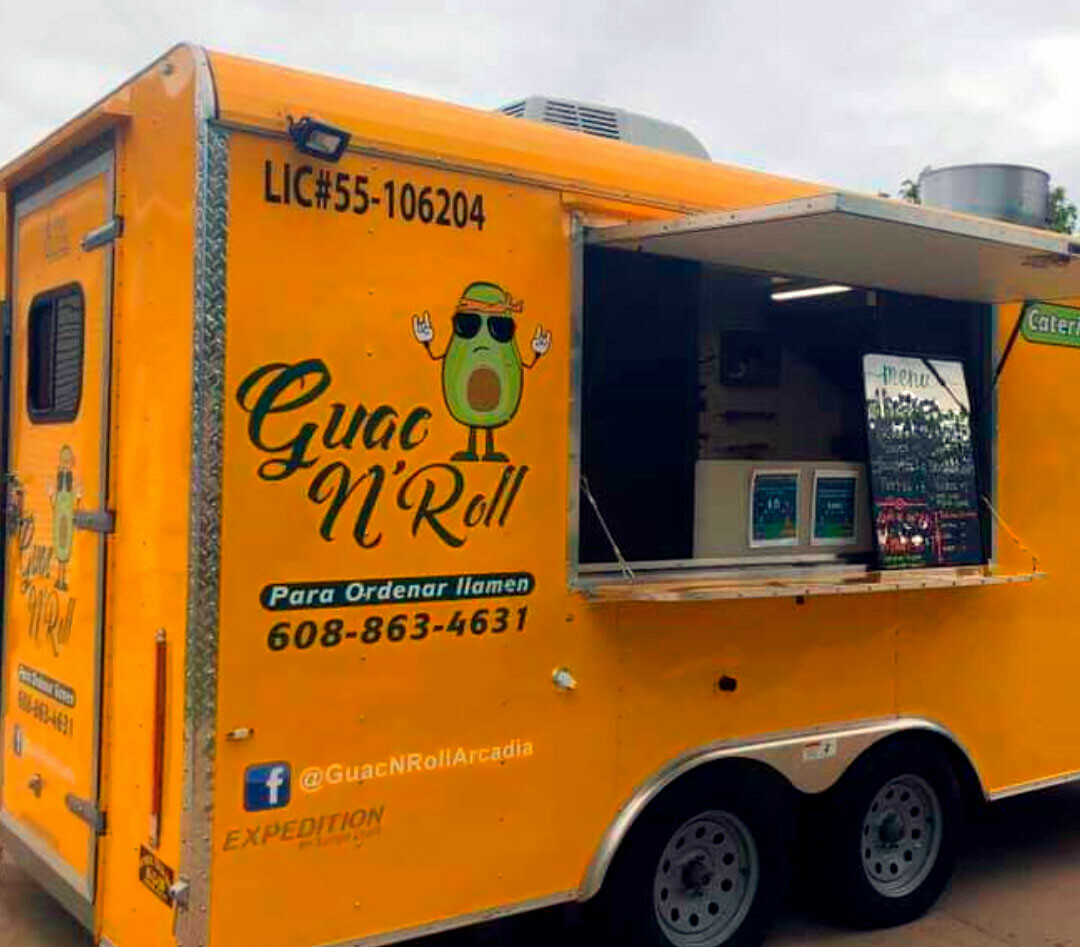 Guac N Roll's bright yellow taco truck.