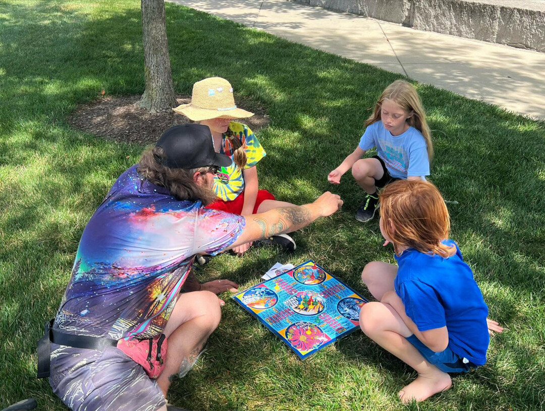 Bremer (lower left) showing people how to play.