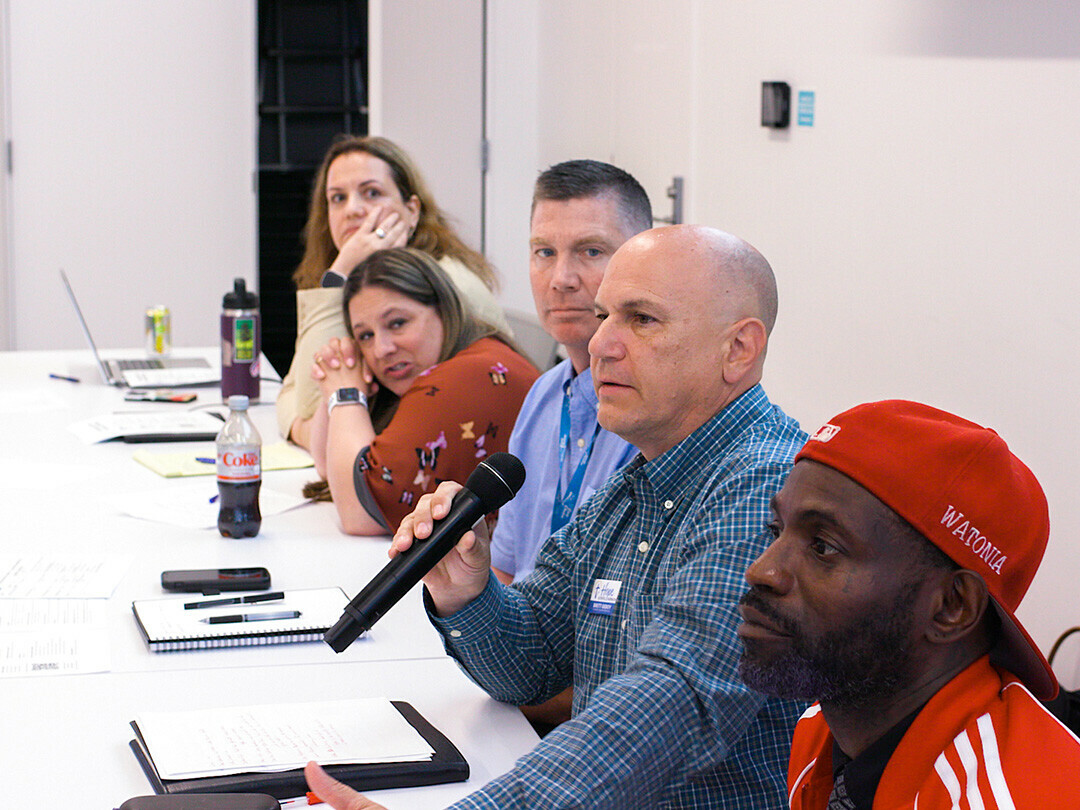 Panelists speak at a June 18 community meeting about the possibility of a day resource center for the homeless.