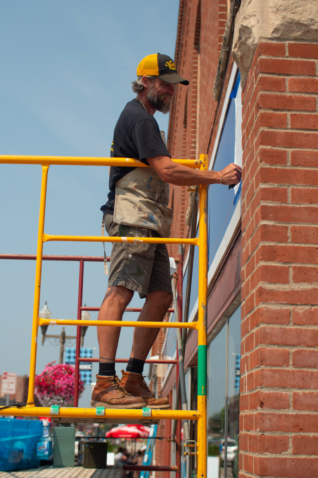 Wade Lambrigsten working on a mural at the 2021 Let's Paint The Town event.