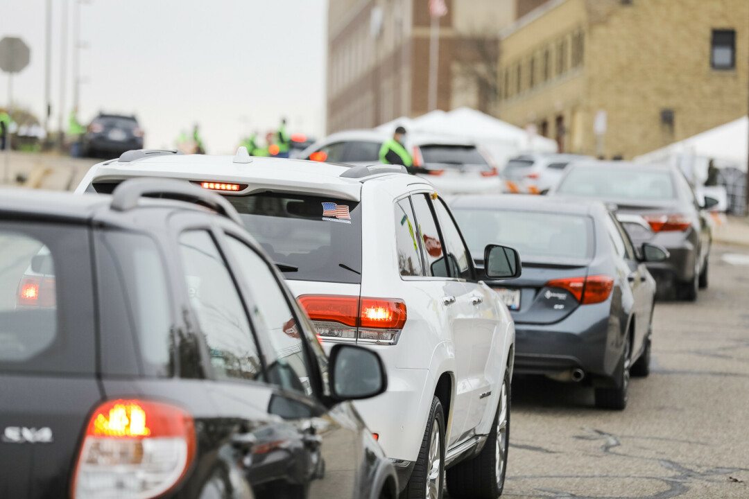 Motorists line up for drive-through voting at Eau Claire City Hall before the 2020 election.