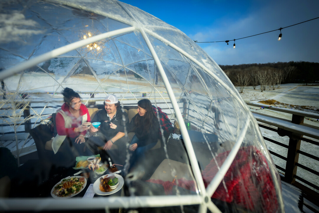 IMBIBING AT THE IGLOOS. Menomonie and area residents now another unique way to enjoy the wintry months: from the warmth of a dining 