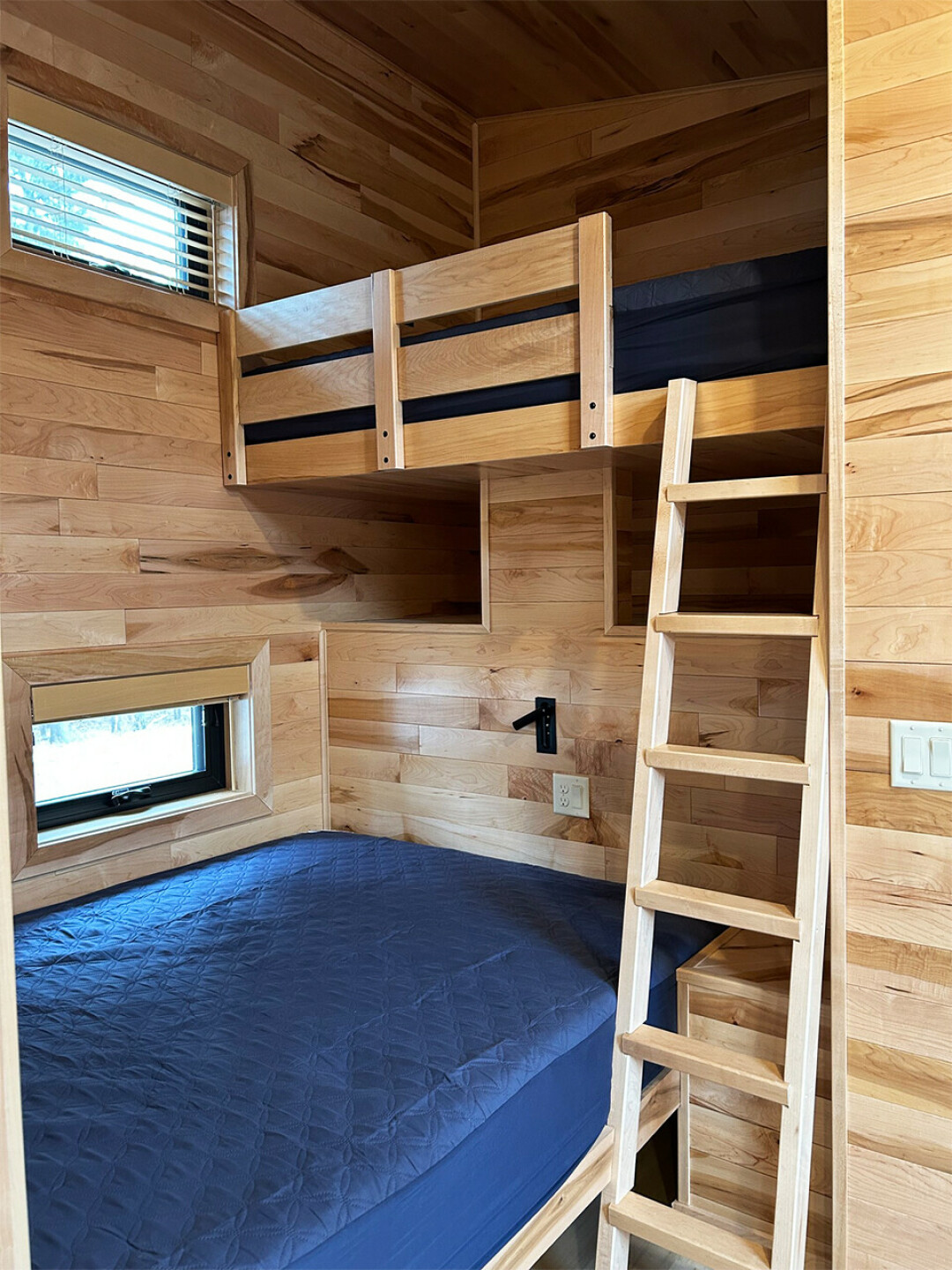 Each camper cabin includes a queen-size bed, full-size loft-style bed and a full-size futon.