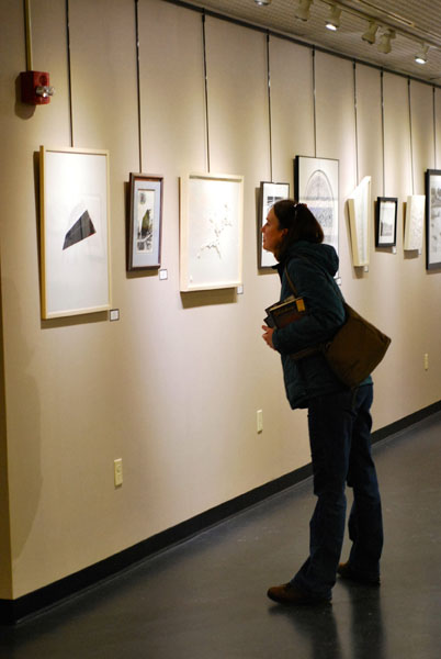 GO WEST, YOUNG ARTIST. A patron eyes the artwork at last year’s ArtsWest exhibit. This year’s installment, ArtsWest 36, opens to the public Feb. 22.